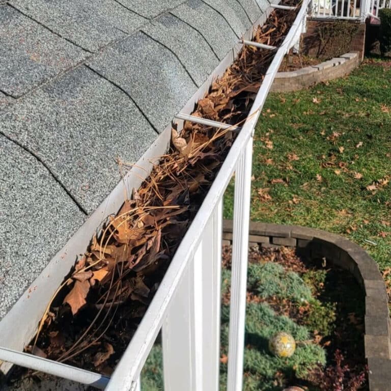 Clogged house gutter before gutter cleaning service in asheboro north carolina