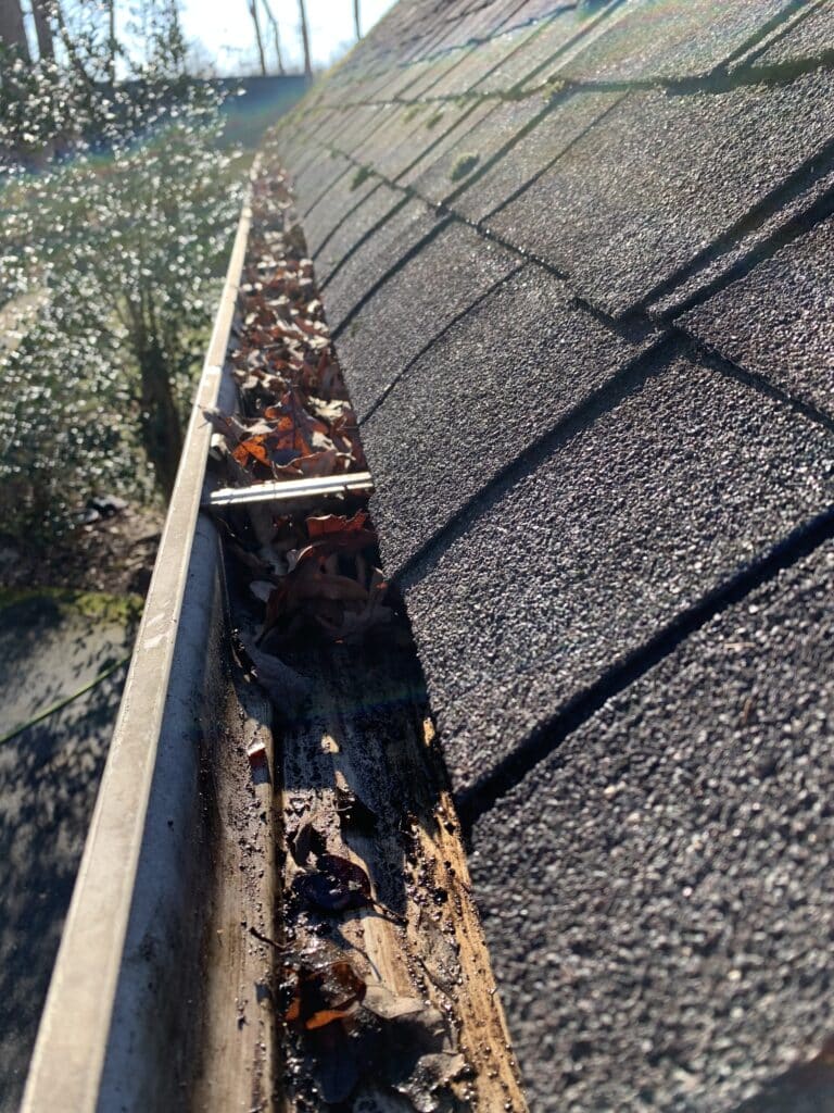 Expert gutter cleaning greensboro with debris removal shown