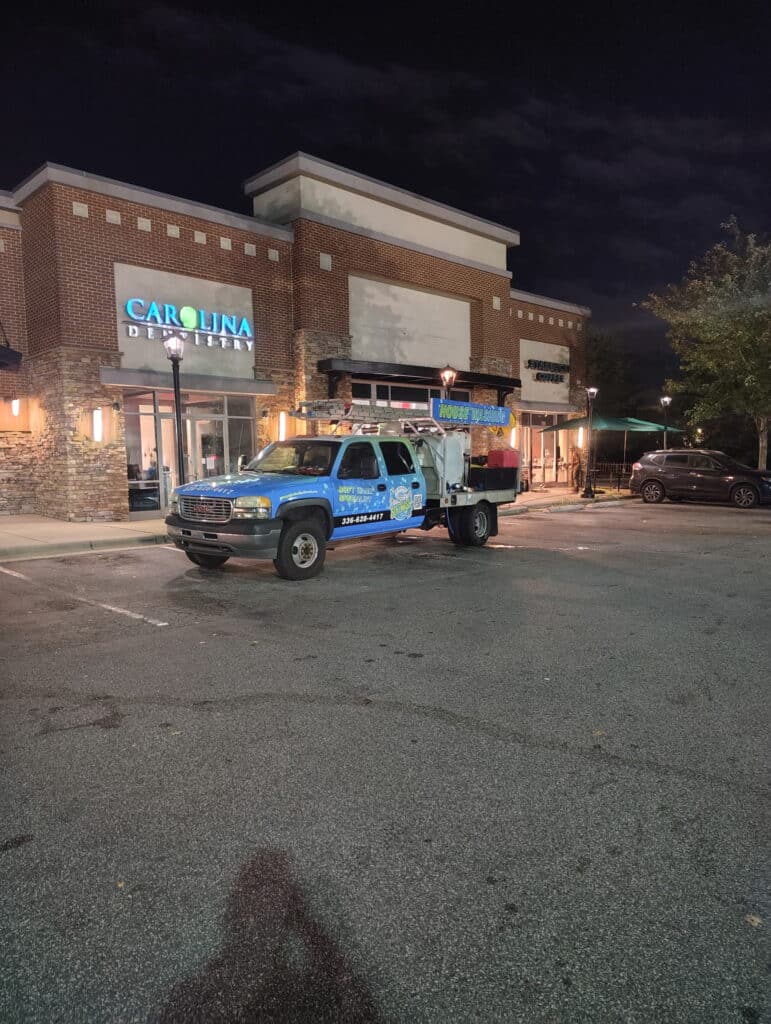 Shopping center pressure washing in Greensboro NC with clean sidewalks and storefronts
